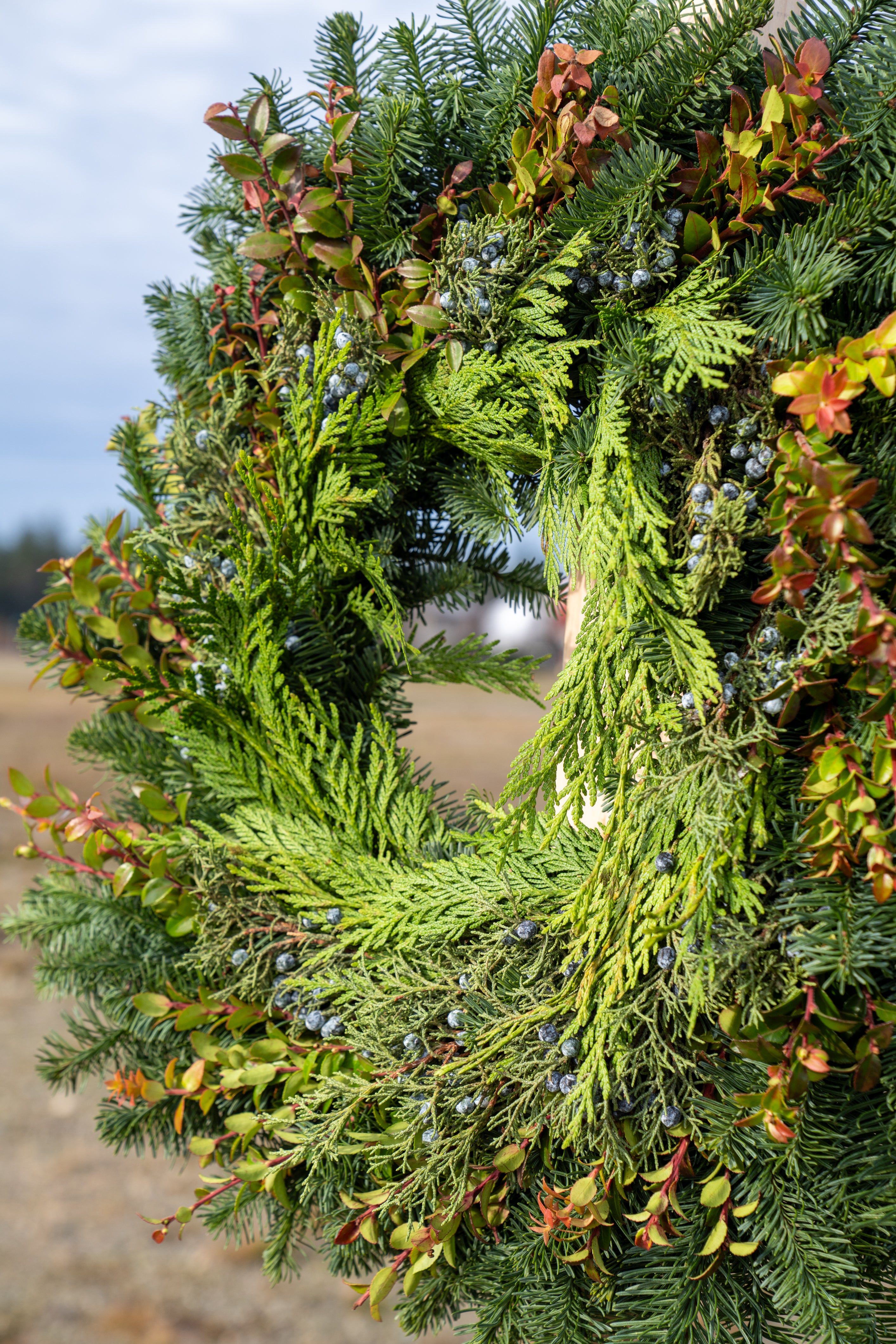 Green wreath with natural elements on a blurred background